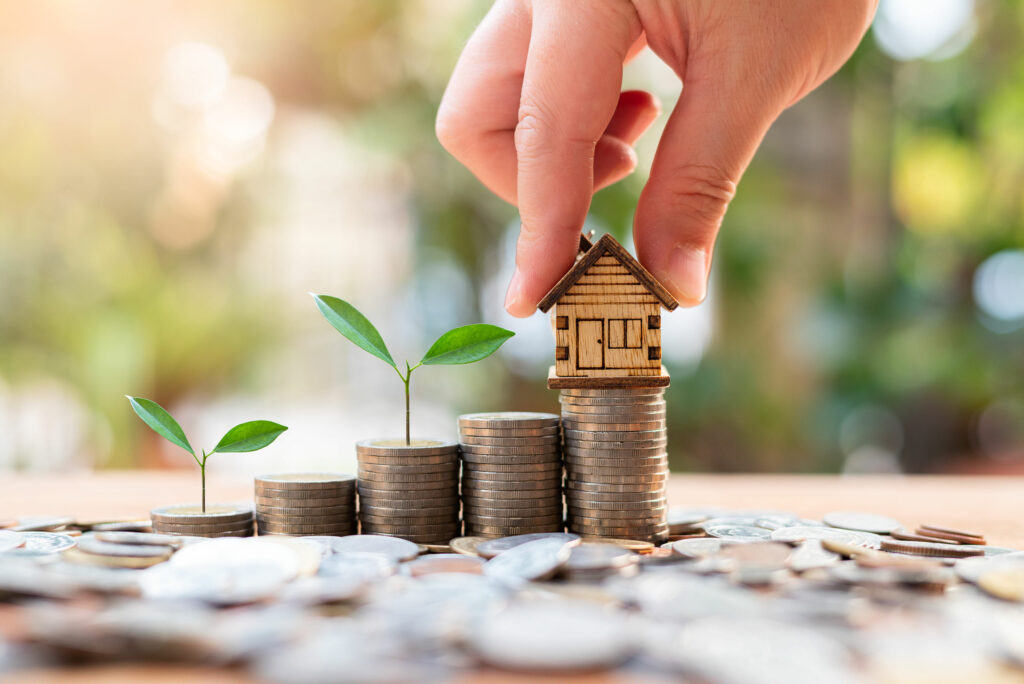 house model on money coins saving for concept investment mortgag